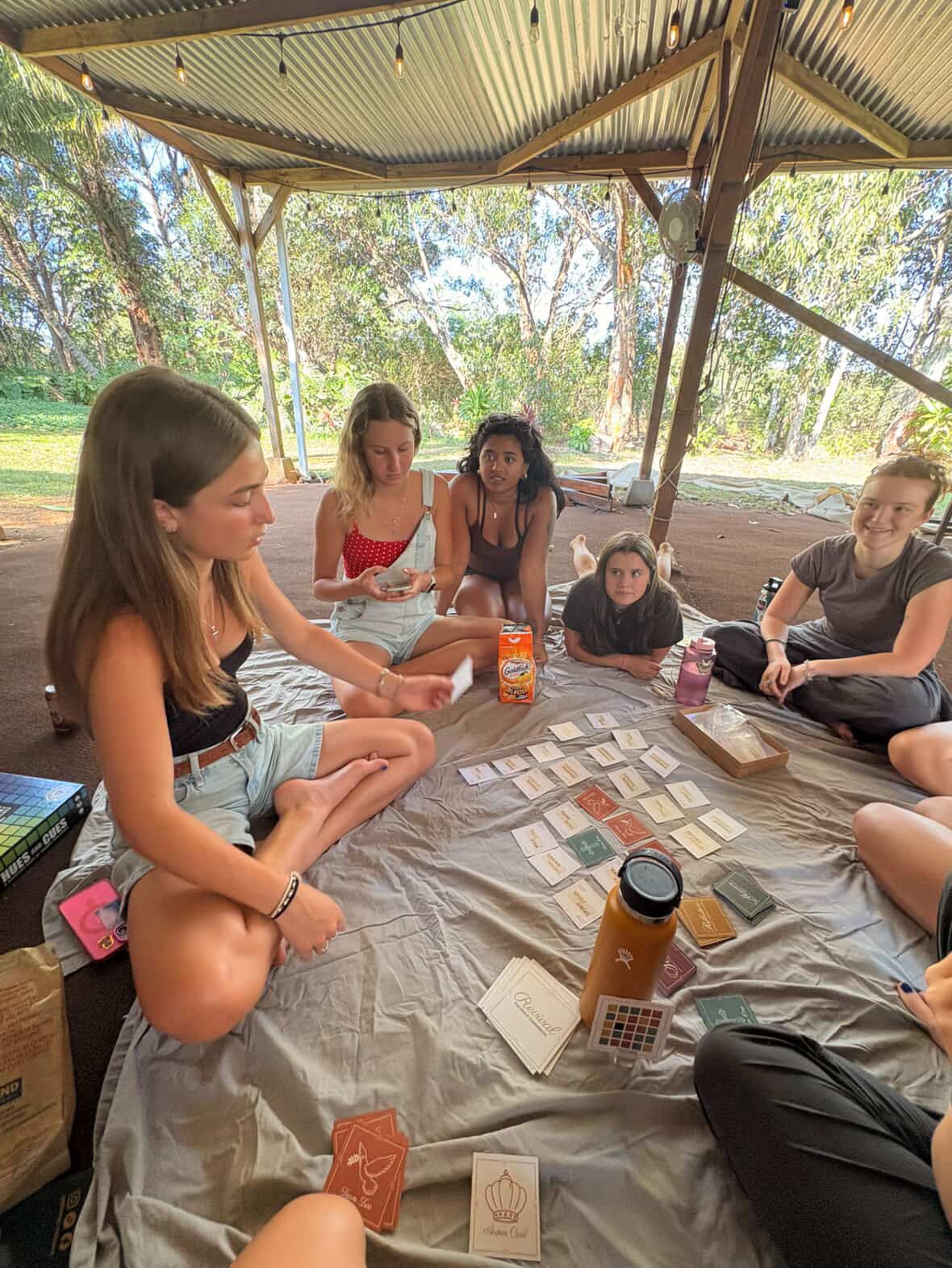 Group playing Revival at an outdoor camp pavilion